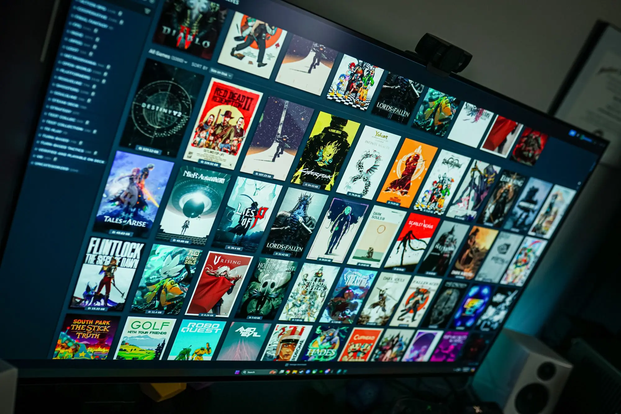 A close-up view of a PC screen displaying a Steam game library with various game covers.
